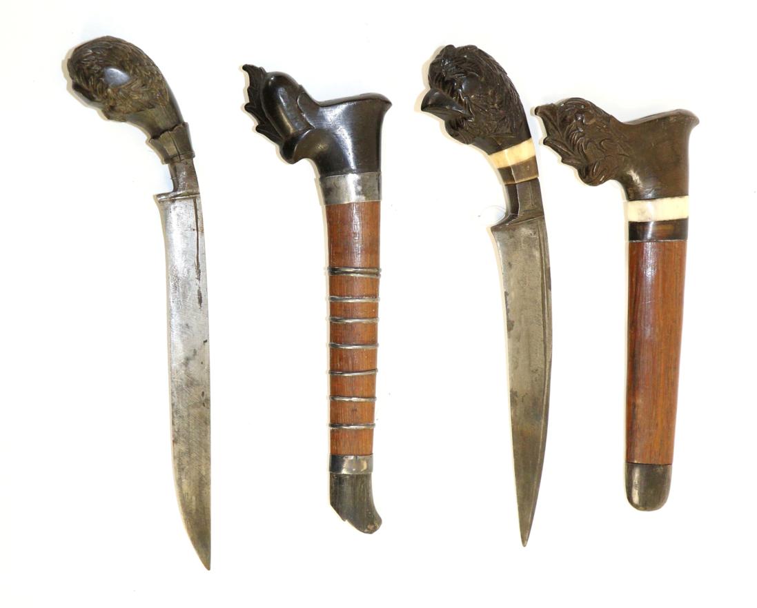 Lot 85 - An Indonesian Badek, the 16cm curved steel blade double edged for the last 8cm, the wood pistol...