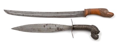 Lot 90 - A 19th Century Philippino Barong, the 32cm double edge elliptical steel blade pierced with a...