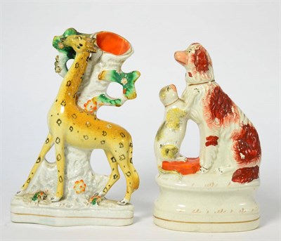 Lot 15 - A Staffordshire Pottery Spill Vase, 19th century, modelled as a giraffe standing before a tree on a