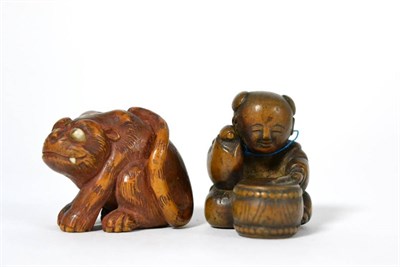 Lot 71 - A Japanese Wood Netsuke, 19th century, as a seated tiger with inlaid eyes, two character signature