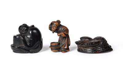 Lot 72 - A Japanese Wood Netsuke, 19th century, as a crouching figure peering into a brazier, signed,...