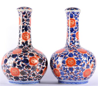 Lot 14 - A Pair of Imari Porcelain Bottle Vases and Covers, 19th century, typically decorated with scrolling