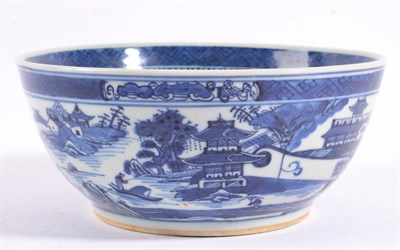 Lot 24 - A Chinese Porcelain Bowl, 19th century, painted in underglaze blue with pagodas in a river...