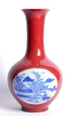 Lot 37 - A Chinese Porcelain Bottle Vase, painted in underglaze blue with river landscapes on a coral...