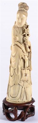 Lot 68 - A Chinese Ivory Figure of Guanyin, 18th century, the standing figure wearing flowing robes...