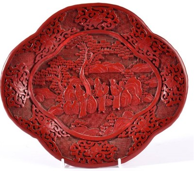 Lot 72 - A Chinese Cinnabar Lacquer Tray, in 18th century style, of lobed oval form, carved with figures...