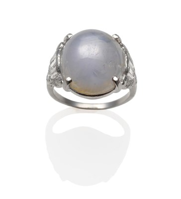 Lot 167 - A Star Sapphire and Diamond Ring, the oval cabochon star sapphire within a white four claw setting