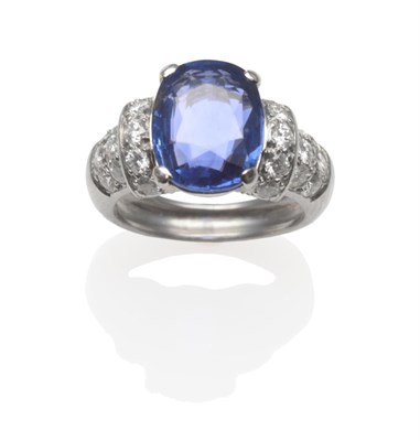 Lot 168 - A Sapphire and Diamond Ring, the oval cut sapphire in a white four claw setting, to round brilliant