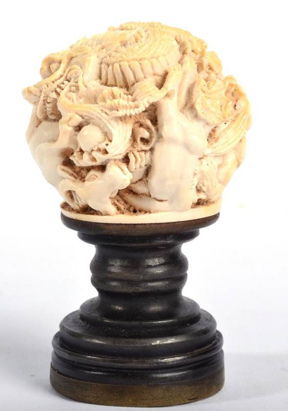 Lot 100 - A Japanese Ivory Ball, Meiji period, carved with a profusion of animals, 4.2cm high, mounted on...