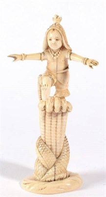 Lot 102 - A Japanese Ivory Okimono, Meiji period, as a boy standing on the back of a serpent, his arms...