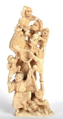 Lot 103 - A Japanese Ivory Okimono, Meiji period, as a monkey trainer, a boy at his feet, 19cm high