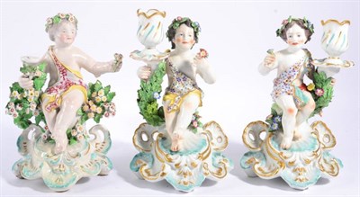 Lot 120 - A Derby Porcelain Figural Chamberstick, circa 1775, modelled as a cherub sitting on a tree...