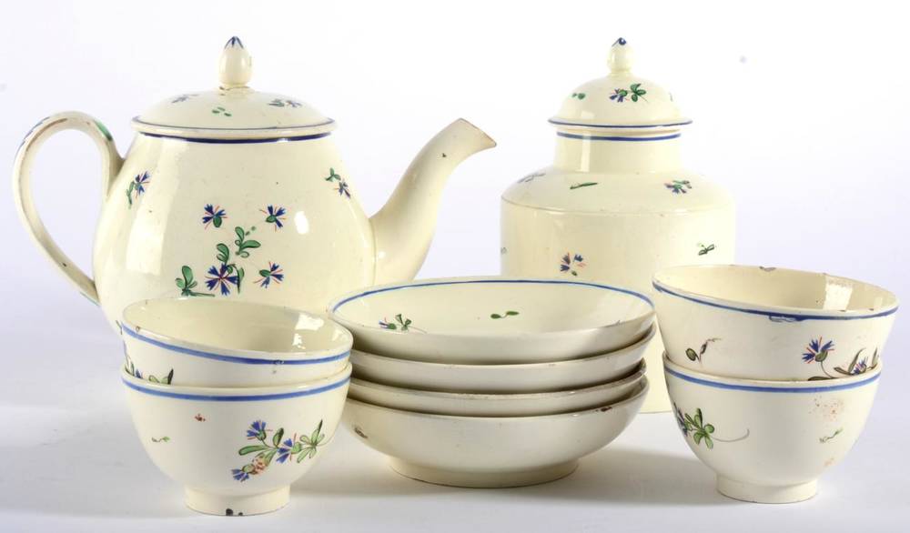 Lot 128 - A Creamware Tea Service, circa 1775, painted with Chantilly Sprig within blue line borders,...