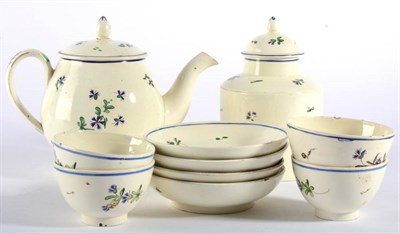 Lot 128 - A Creamware Tea Service, circa 1775, painted with Chantilly Sprig within blue line borders,...