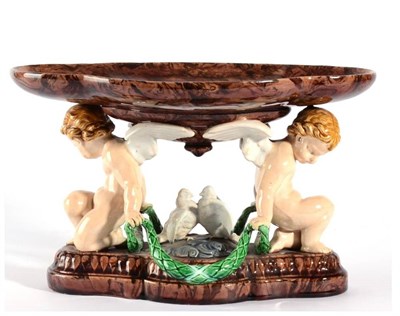 Lot 145 - A Minton Majolica Centrepiece, 1870, the lobed oval bowl supported by two putti flanking a pair...