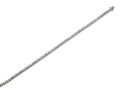 Lot 188 - An 18 Carat White Gold Diamond Line Bracelet, the round brilliant cut diamonds in claw...