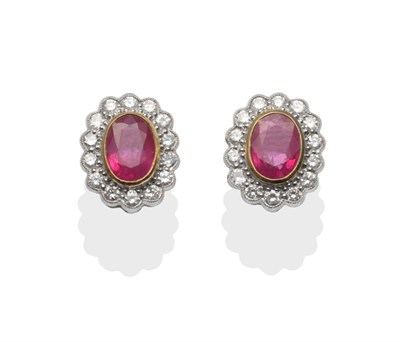 Lot 192 - A Pair of 18 Carat White Gold Ruby and Diamond Cluster Earrings, the oval mixed cut rubies in a...