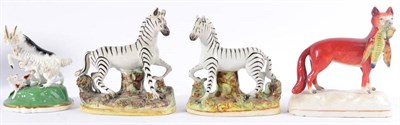 Lot 199 - A Staffordshire Porcellanous Figure Group of a Goat and Kid, mid 19th century, on a green wash...