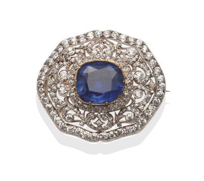 Lot 208 - A Sapphire and Diamond Brooch, the cushion shaped sapphire in a yellow collet closed back...