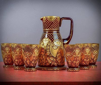 Lot 264 - A Bohemian Ruby Glass Water Set, late 19th century, cut and gilt with panels of flowers and...