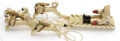 Lot 303 - An Early 20th Century Ivory Group of an Eskimo, with sledge and four dogs, sledge 12cm long