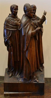 Lot 386 - A Carved Wood Figure Group, 20th century, depicting the Pope and two attendants, reading from a...