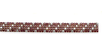 Lot 274 - ~ A Ruby and Diamond Bracelet, four rows of round cut rubies and round brilliant cut diamonds,...