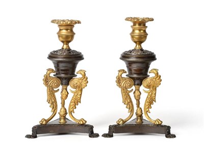 Lot 405 - A Pair of Gilt and Patinated Bronze Candlesticks, in Empire style, with urn shape sconces on...