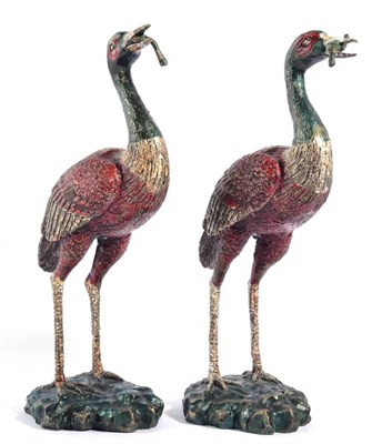 Lot 428 - A Pair of Cold Painted Bronze Figures of Cranes, 20th century, each standing with a fish in...