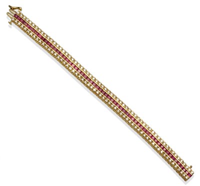 Lot 301 - ~ A Ruby and Diamond Bracelet, one row of calibré cut rubies between two rows of round brilliant