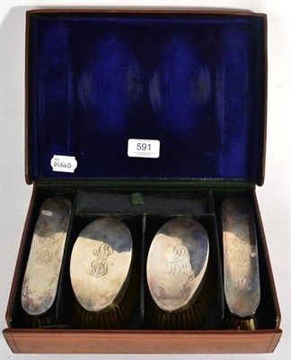 Lot 591 - A Set of Four Silver Brushes, William Comyns, London 1910, in a fitted leather case, engraved...