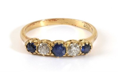 Lot 665 - A Sapphire and Diamond Ring, two round cut sapphires spaced by two old cut diamonds, in a...