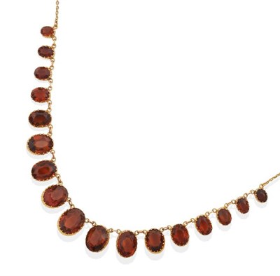 Lot 668 - A Citrine Riviere Necklace, graduated oval cut citrine in collet settings, to a trace chain...