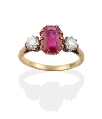 Lot 672 - A Ruby and Diamond Three Stone Ring, a rectangular cushion cut ruby in a claw setting, between...