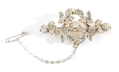 Lot 676 - A Diamond Floral Brooch, an old cut diamond in a claw setting, spaced by diamond set leaves,...