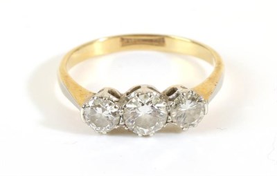 Lot 684 - A Diamond Three Stone Ring, graduated round brilliant cut diamonds in claw settings, to knife...