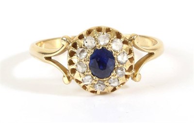 Lot 685 - A Sapphire and Diamond Cluster Ring, an oval cut sapphire within a border of rose cut diamonds,...