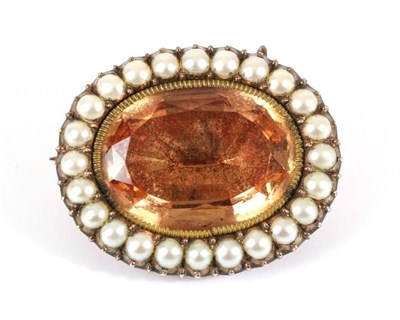 Lot 691 - A Circa 1820 Topaz and Seed Pearl Brooch, an oval cut foil backed golden topaz in a collet setting