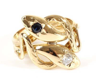 Lot 692 - A Sapphire and Diamond Snake Ring, two coiled snakes with a star set round cut sapphire and...