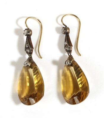 Lot 693 - A Pair of Citrine and Diamond Pendant Earrings, an old cut diamond set scroll bar suspends a...