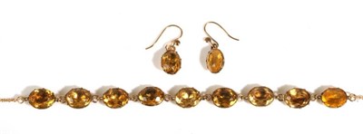 Lot 698 - A Circa 1850 Gilt Metal and Citrine Riviere Necklace and Earring Suite, foil backed oval cut...