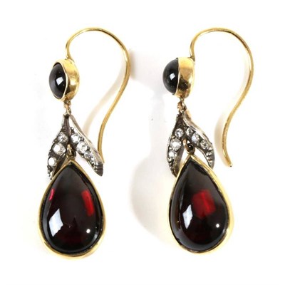 Lot 704 - A Pair of Garnet and Diamond Pendant Earrings, a round cabochon garnet in a rubbed over setting...