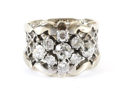 Lot 715 - A Diamond Cluster Ring, round brilliant cut and old cut diamonds in claw settings, to a fancy...