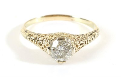 Lot 718 - A Solitaire Diamond Ring, a round brilliant cut diamond in a claw setting, to tapering filigree...