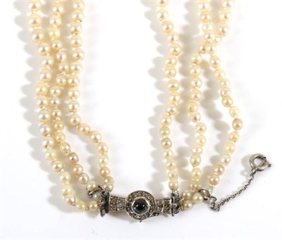 Lot 726 - An Art Deco Triple Row Cultured Pearl Necklace, with a Sapphire and Diamond Set Clasp,...