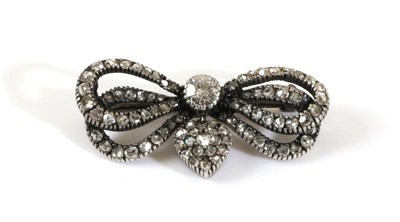 Lot 747 - A Diamond Bow Brooch, a central old cut diamond in a milgrain setting, to a rose cut diamond double