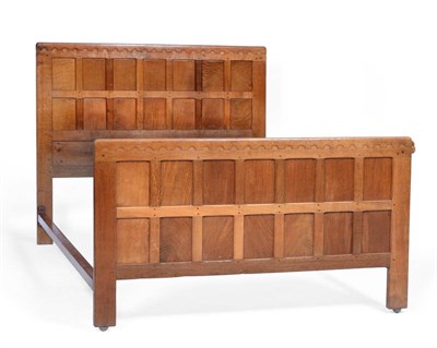 Lot 524 - A Robert  "Mouseman " Thompson Panelled Oak 4'6 " Bedstead, with penny moulded top, carved...