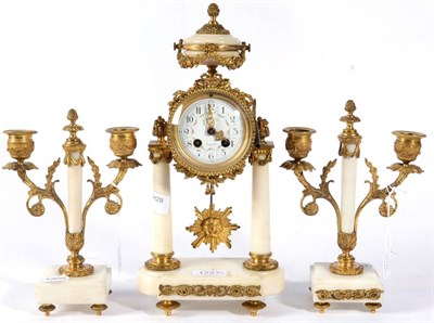 Lot 1227 - A Gilt Metal and White Marble Portico Striking Mantel Clock with Garniture, retailed by S.Bentejar