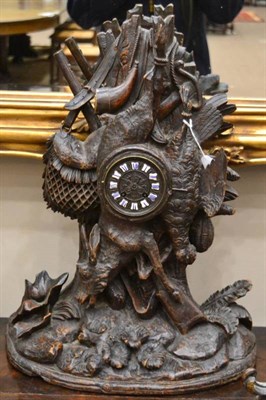 Lot 1253 - A Carved Black Forest Striking Mantel Clock, circa 1880, carved case depicting a hunting theme,...