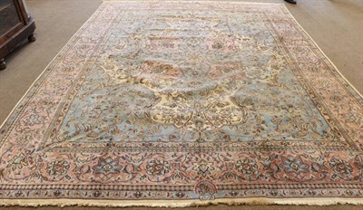 Lot 1268 - Kirman Carpet South East Iran, 1950 The ivory field centred by a sky blue and coral pink...